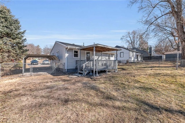 exterior space with a carport, a front yard, fence, and a wooden deck