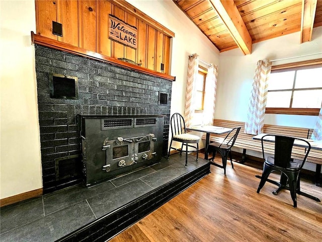 interior space featuring wood ceiling, a fireplace, wood finished floors, and a wealth of natural light