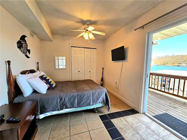 tiled bedroom with a ceiling fan, a closet, visible vents, and baseboards