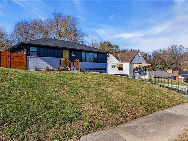 view of front of house with fence and a front yard