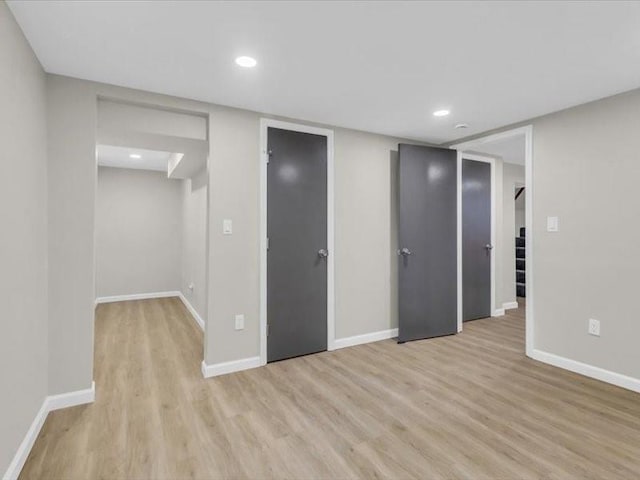 interior space featuring light wood-style floors, baseboards, and recessed lighting