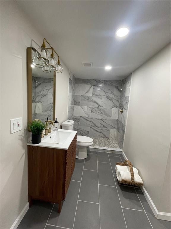 full bath with visible vents, toilet, vanity, a shower stall, and tile patterned flooring