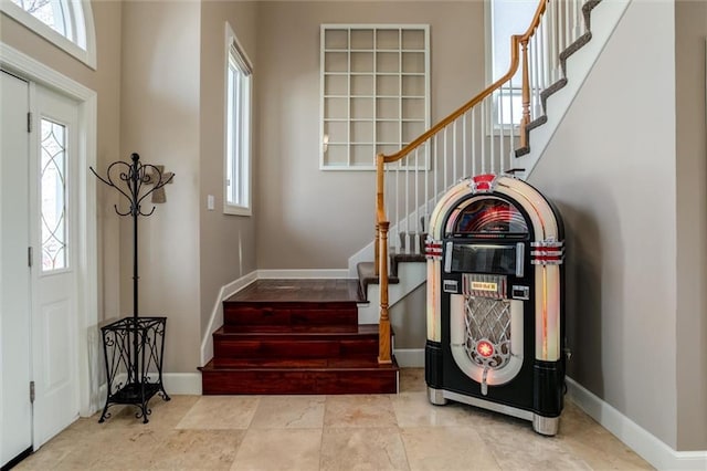 entrance foyer featuring stairs and baseboards