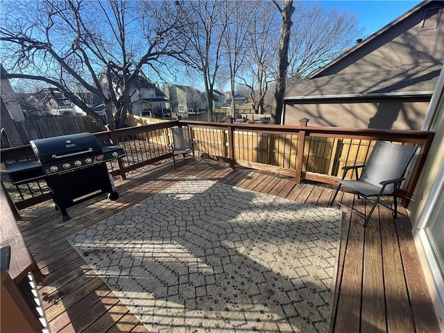 deck with grilling area, fence, and a residential view