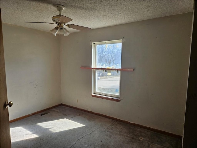 empty room with a textured ceiling, light carpet, visible vents, and baseboards