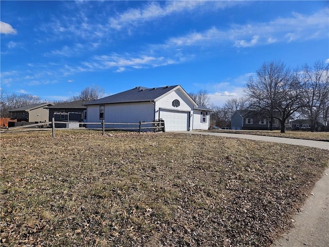 view of front of house featuring a garage and fence