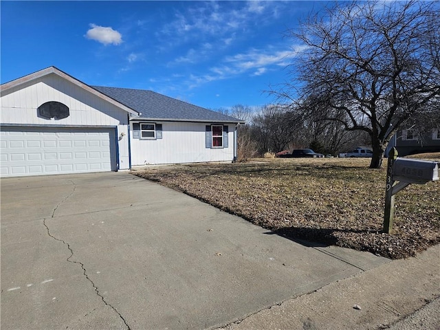 view of front facade featuring a garage, concrete driveway, and roof with shingles