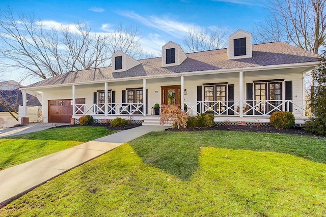 new england style home featuring a garage, driveway, a shingled roof, covered porch, and a front lawn