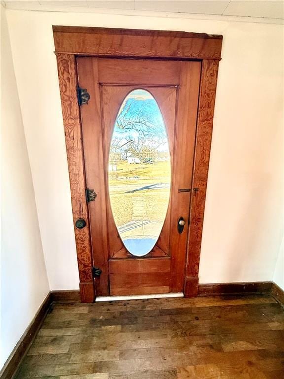 doorway featuring dark wood-style floors and baseboards