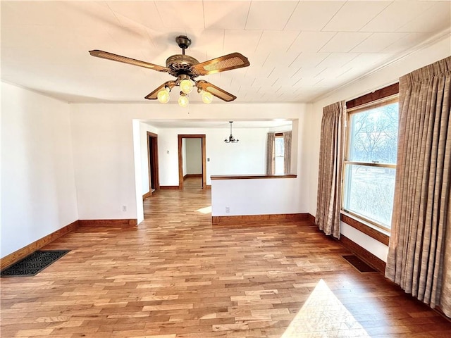 spare room with light wood-style flooring, visible vents, and ceiling fan