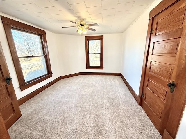 unfurnished room featuring ceiling fan, carpet floors, and baseboards