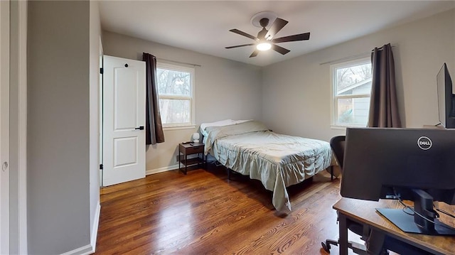 bedroom featuring baseboards, a ceiling fan, and wood finished floors