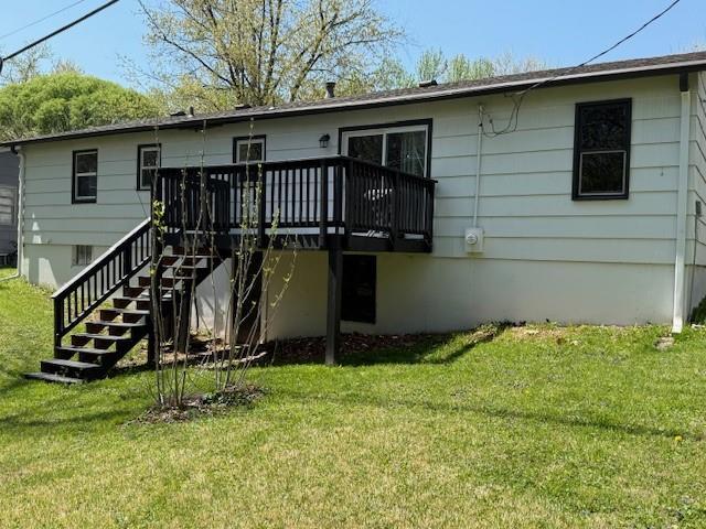 back of house featuring a wooden deck, stairway, and a yard
