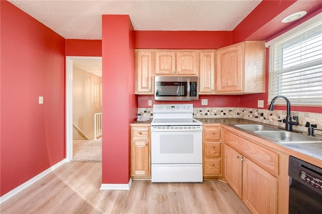 kitchen with dishwasher, stainless steel microwave, white electric range, light brown cabinets, and a sink