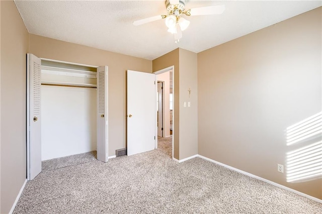 unfurnished bedroom featuring ceiling fan, a closet, baseboards, and carpet flooring