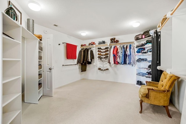 walk in closet with carpet