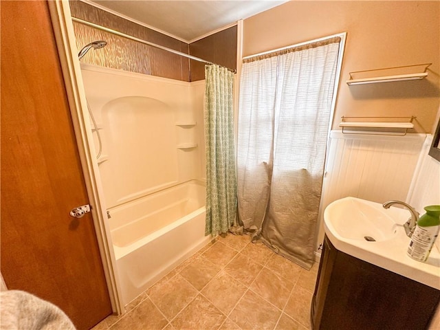 bathroom featuring a wainscoted wall, tile patterned floors, shower / tub combo with curtain, and vanity