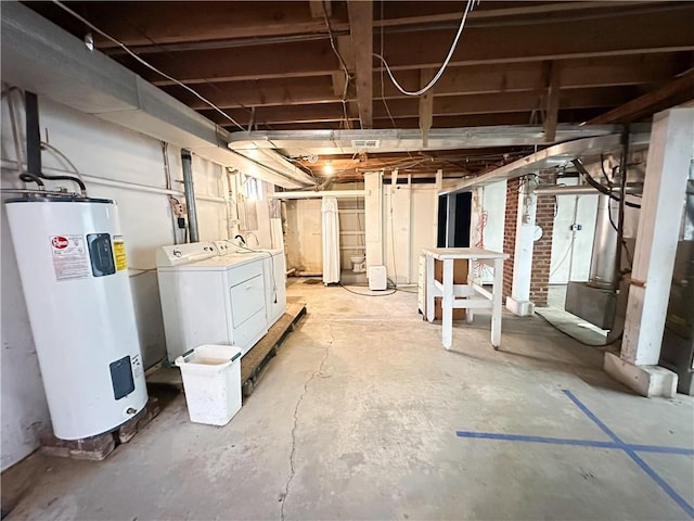 unfinished basement with washing machine and dryer and water heater