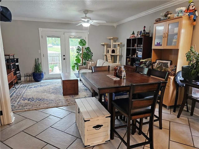 dining room featuring ornamental molding, ceiling fan, french doors, and a textured ceiling