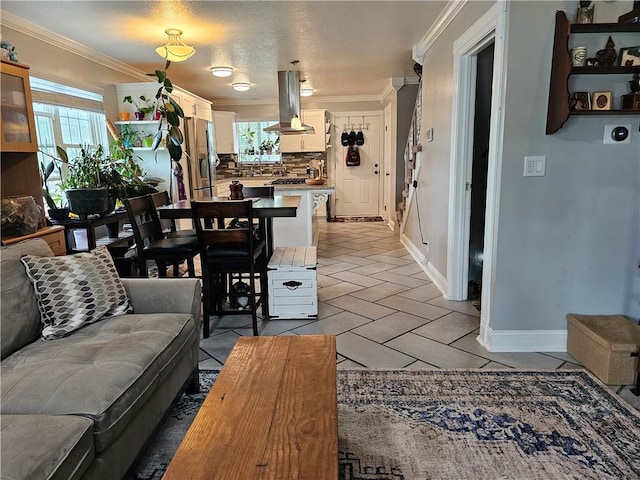 living room featuring plenty of natural light, baseboards, and crown molding