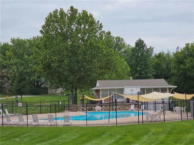 pool with fence and a lawn