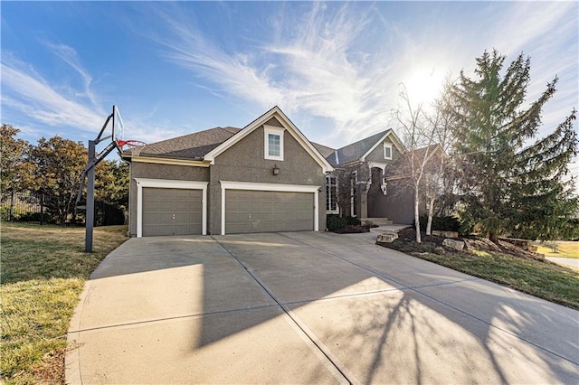 traditional-style home with a front yard, driveway, an attached garage, and stucco siding