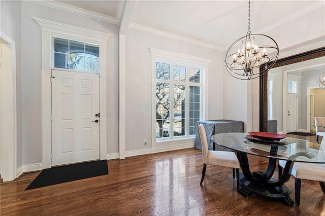 dining space with baseboards, ornamental molding, dark wood finished floors, and a chandelier