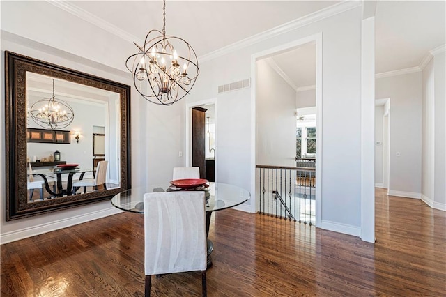 dining area with crown molding, wood finished floors, visible vents, and a notable chandelier