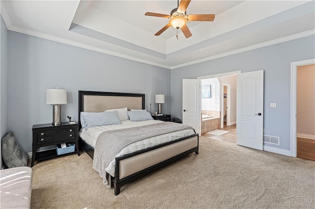 bedroom featuring light colored carpet, a raised ceiling, visible vents, and baseboards