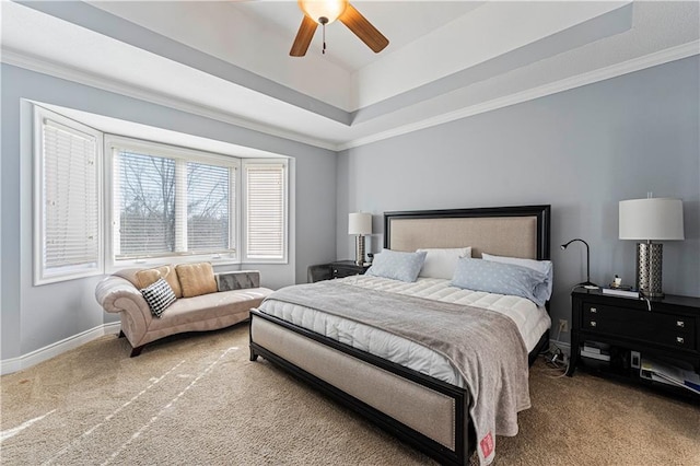 bedroom featuring carpet floors, ornamental molding, a raised ceiling, and baseboards