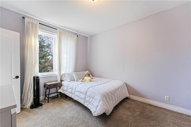 carpeted bedroom featuring baseboards