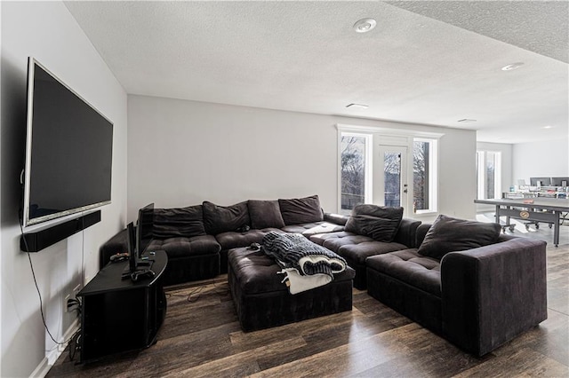 living room featuring a textured ceiling and wood finished floors