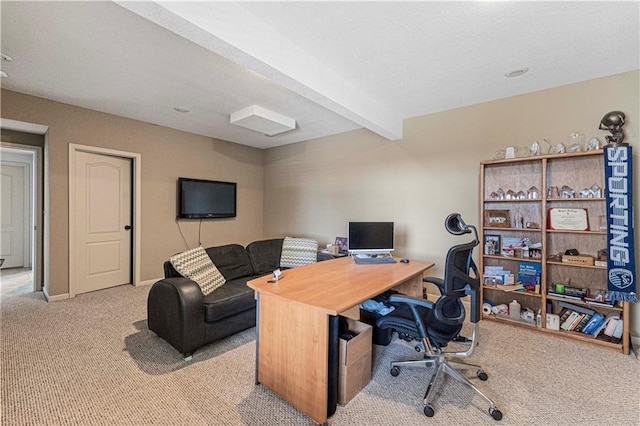 office space featuring carpet, beamed ceiling, and baseboards