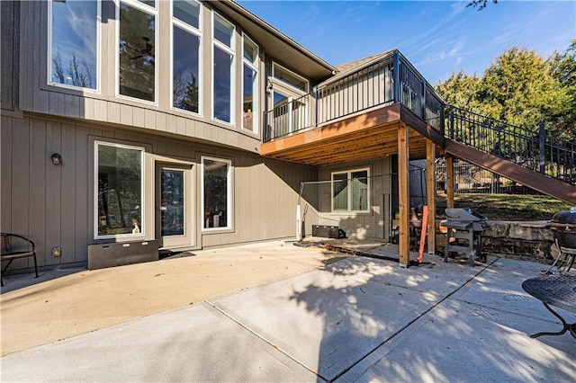 back of property with a patio, stairway, and a wooden deck