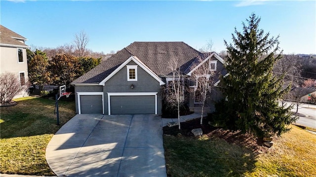 traditional-style house with driveway, a shingled roof, a front yard, and stucco siding