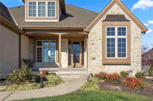 property entrance featuring a porch, roof with shingles, stucco siding, and stone siding