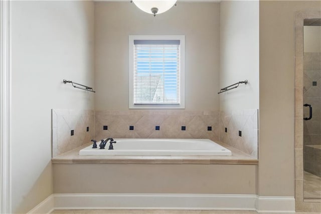 full bath featuring a garden tub and a stall shower