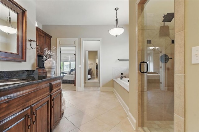 ensuite bathroom with tile patterned floors, a shower stall, a bath, and connected bathroom