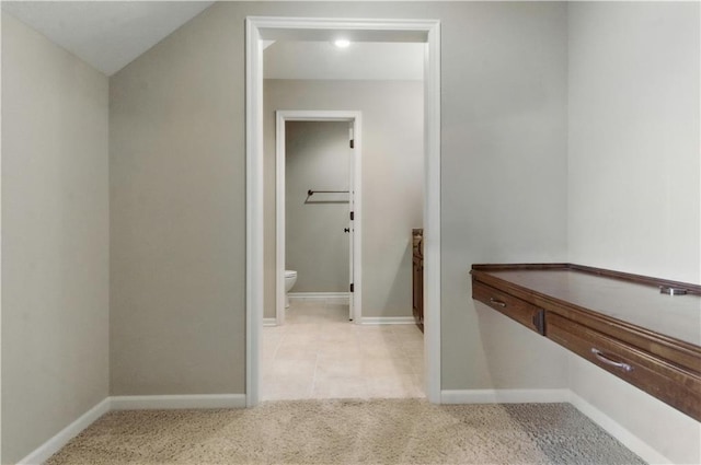 bathroom featuring baseboards and toilet
