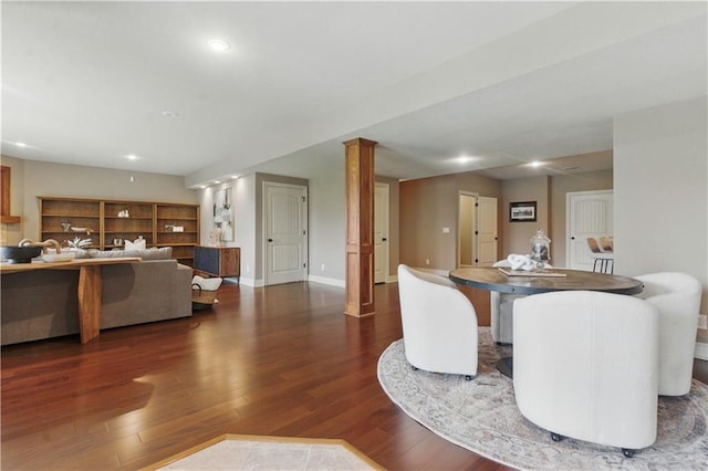 living room with recessed lighting, baseboards, and wood finished floors
