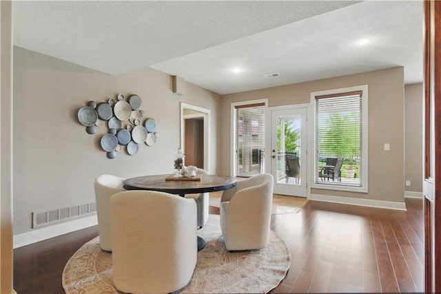 dining space with recessed lighting, baseboards, visible vents, and wood finished floors