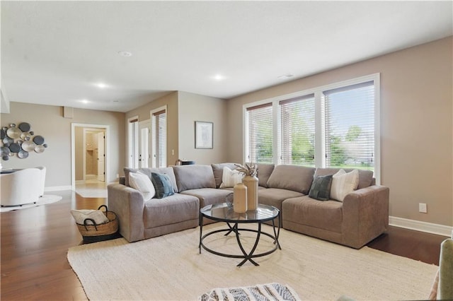 living area featuring baseboards, recessed lighting, and wood finished floors