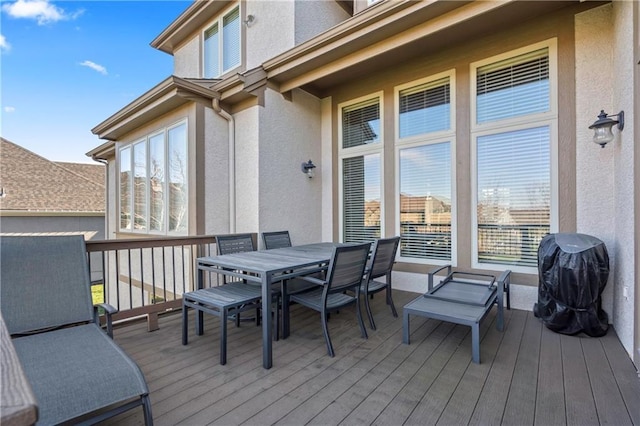 wooden deck featuring outdoor dining area