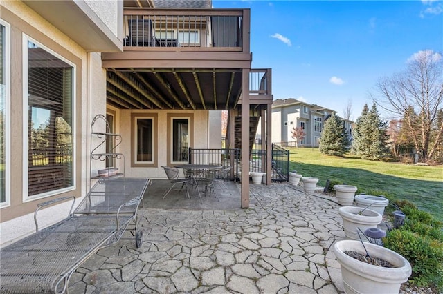 view of patio / terrace with a balcony and outdoor dining space
