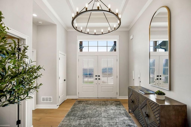 16649 S Tomashaw St, Olathe, KS 66062 - entrance foyer with light wood-style floors, french doors, visible vents, and a chandelier