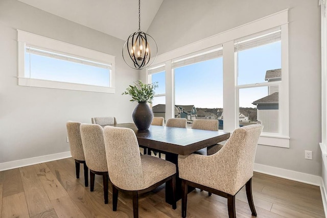 16649 S Tomashaw St, Olathe, KS 66062 - dining room with light wood-style floors, baseboards, lofted ceiling, and a notable chandelier