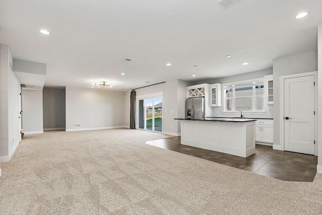 16649 S Tomashaw St, Olathe, KS 66062 - kitchen featuring recessed lighting, stainless steel fridge, dark countertops, white cabinets, and carpet floors