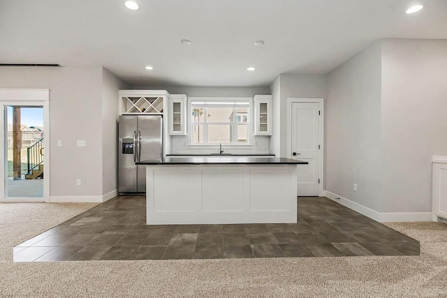 16649 S Tomashaw St, Olathe, KS 66062 - kitchen featuring dark countertops, baseboards, stainless steel refrigerator with ice dispenser, and white cabinets