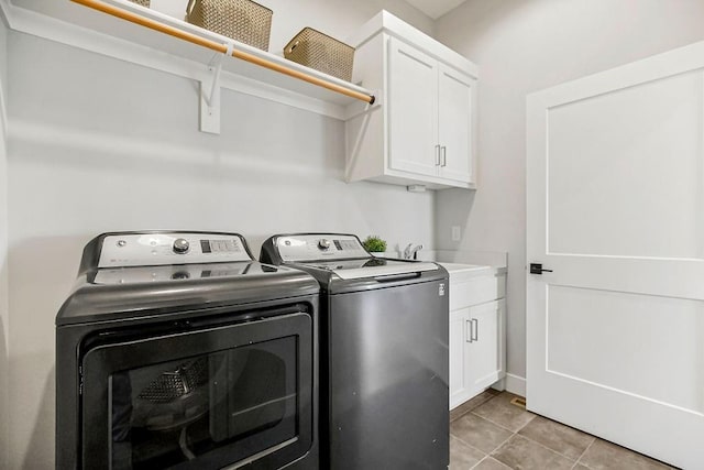 16649 S Tomashaw St, Olathe, KS 66062 - clothes washing area featuring light tile patterned floors, a sink, washing machine and dryer, and cabinet space
