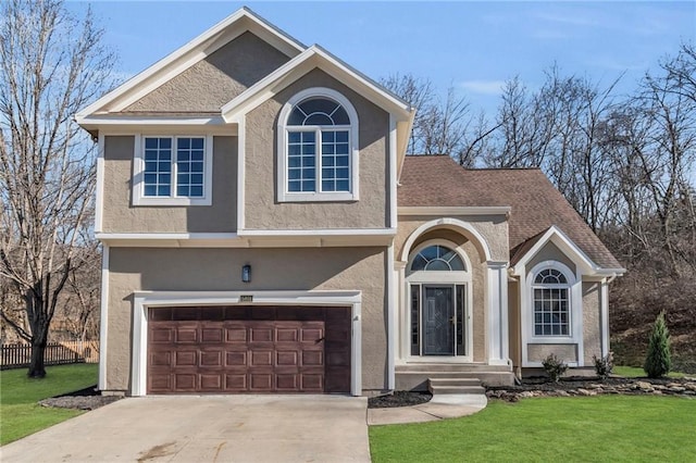 view of front facade featuring stucco siding, an attached garage, a front yard, fence, and driveway